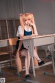 A girl sitting at a desk in a classroom.